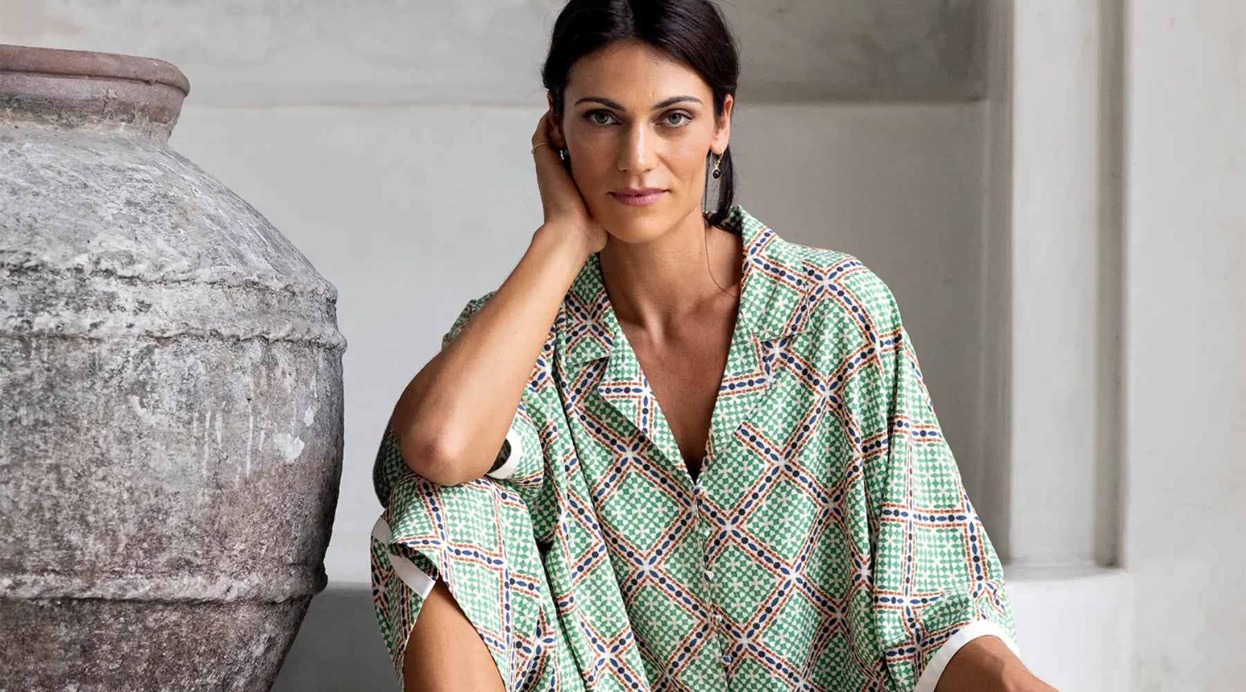 brunette woman looking straight ahead with new bright green blue patterned humidity clothing 